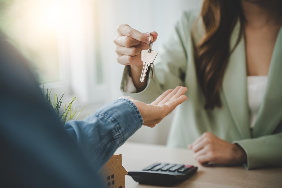 A property manager giving tenants keys to their new home