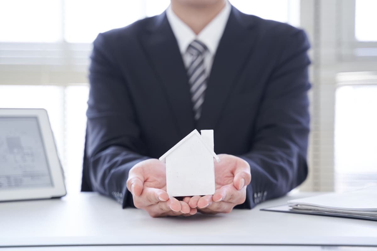 A property manager holds a model house