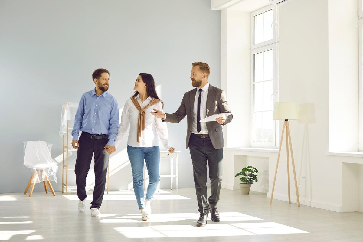 Professional man showing a couple a property