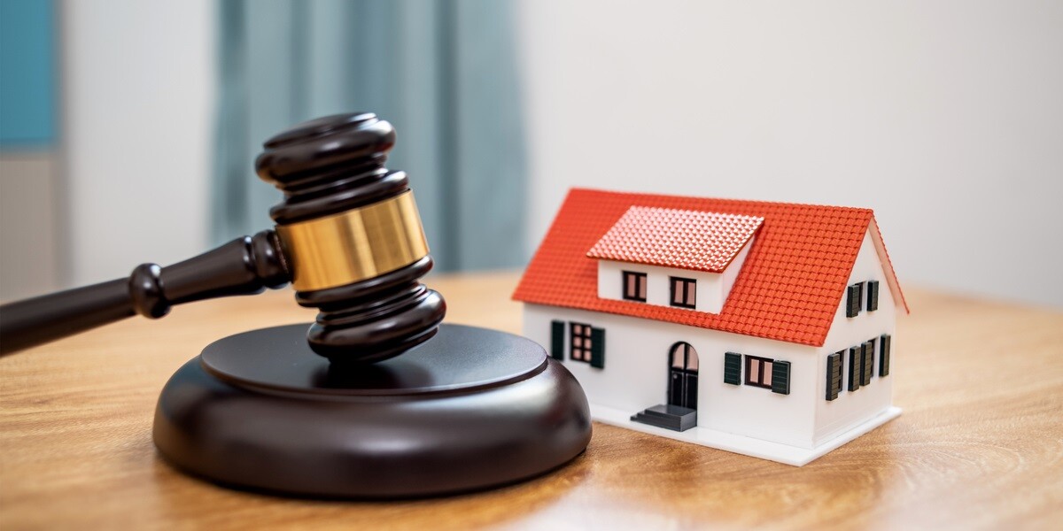 A gavel and small house on a table, Fair Housing Act concept