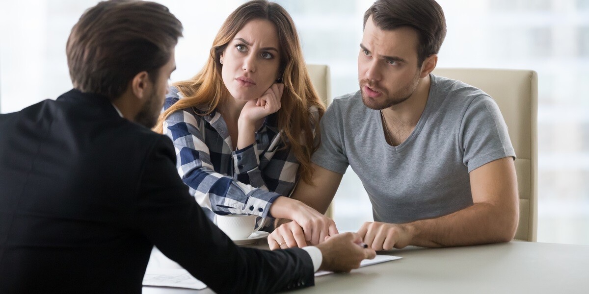 An angry couple talking with a man in a suit