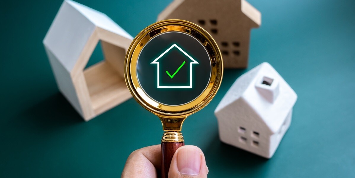 Three small wooden homes with a checkmark on it